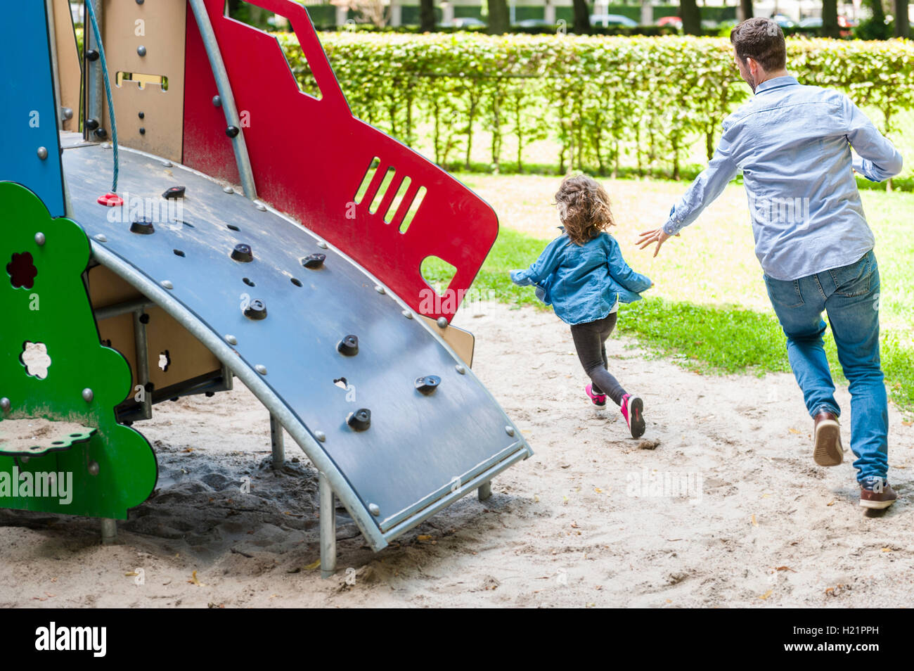 Run With Daughter Rfds Father running with daughter on playground Stock Photo - Alamy