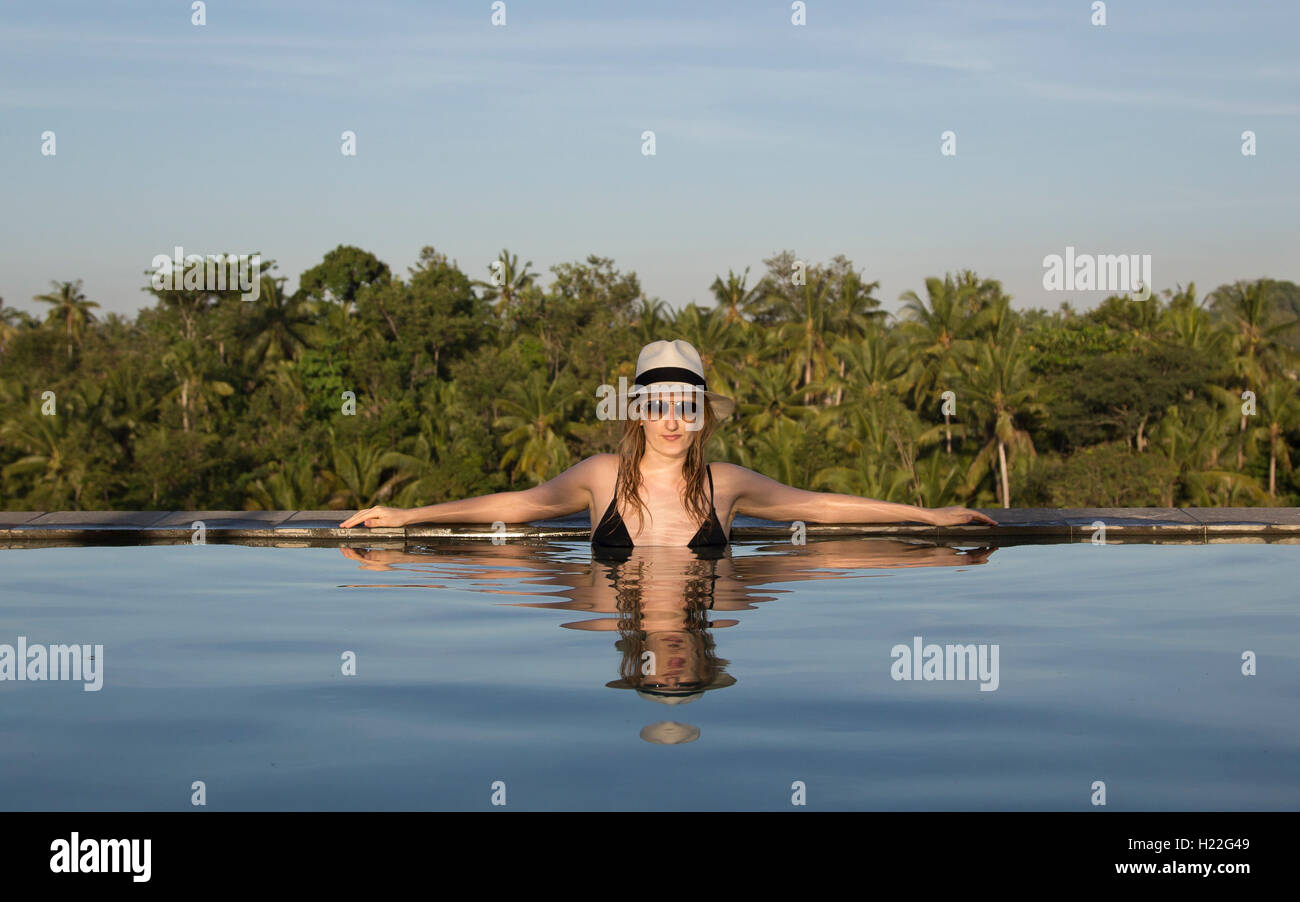 young woman in a swimming pool in Bali Stock Photo