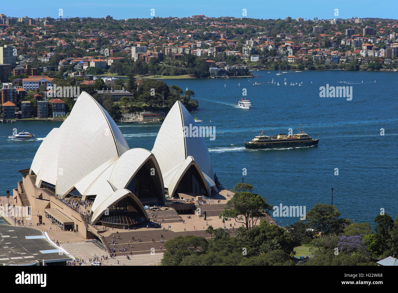 Aerial view of Sydney harbour ferries passing Sydney Opera House New South Wales Australia Stock Photo