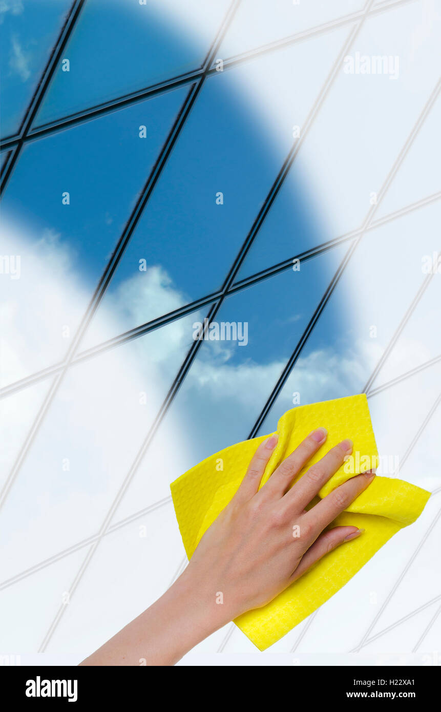 hand cleaning window making it easier to glass office building through