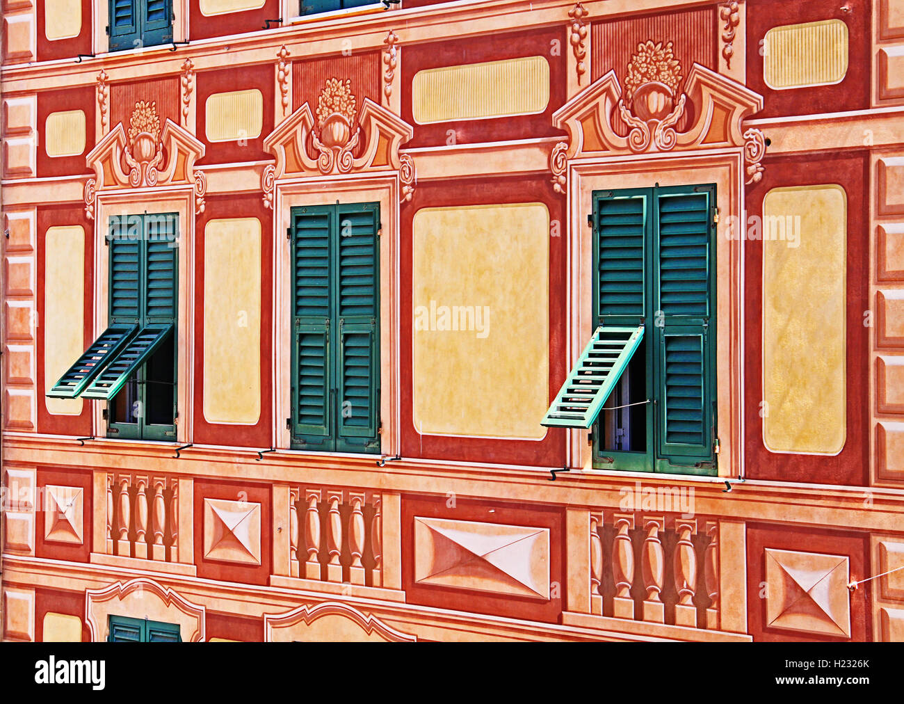Ligurian facade house painted with typical colors in forced perpective