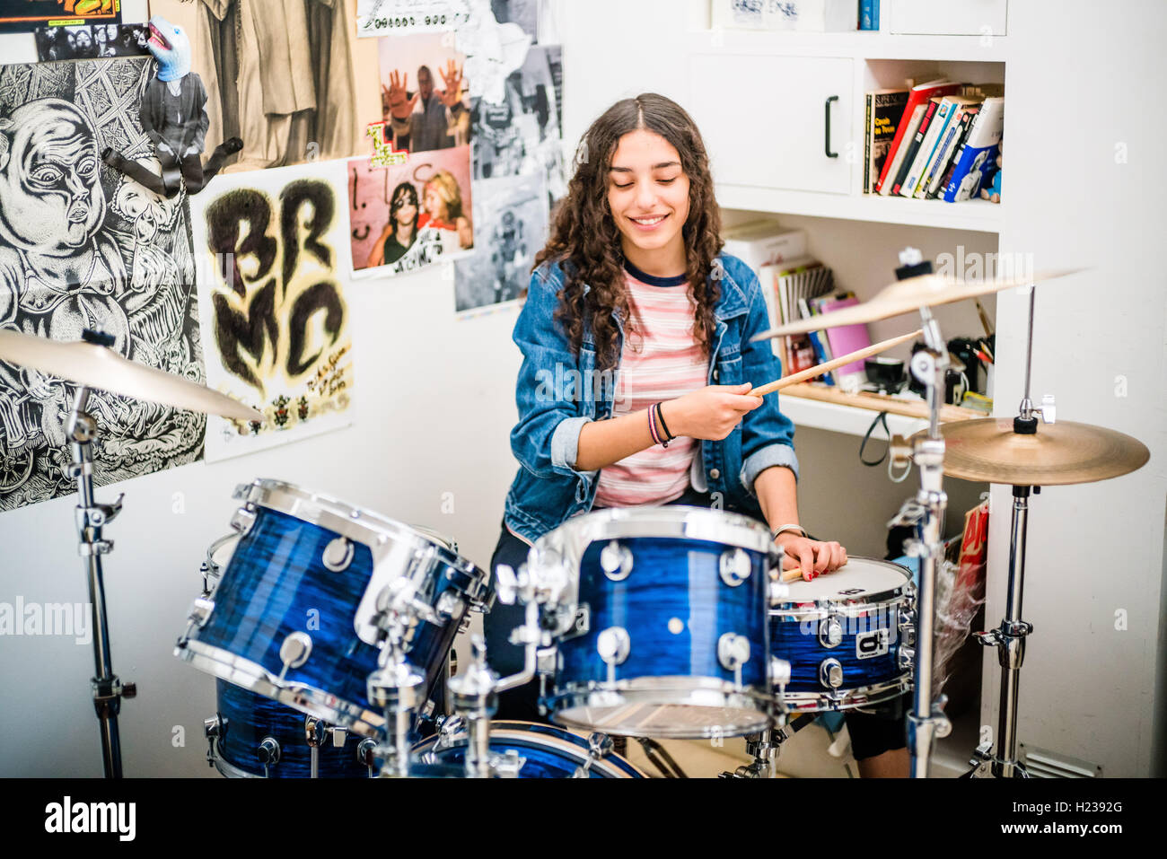 Teenage girl playing drums. Stock Photo