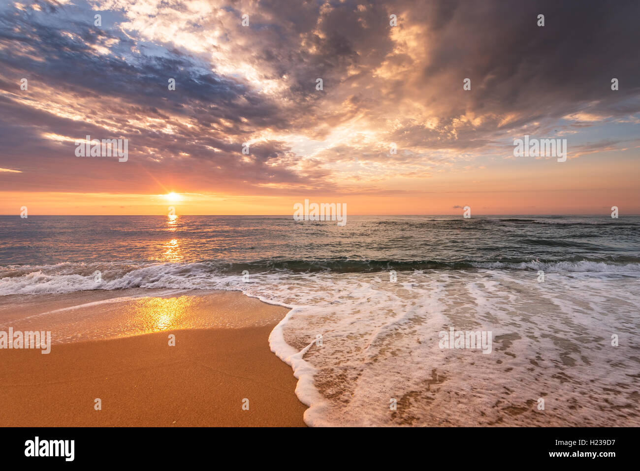 Brilliant ocean beach sunrise. Stock Photo