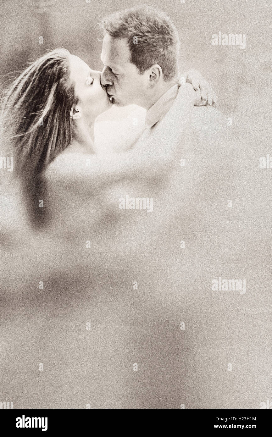 young woman and man kissing each other Stock Photo