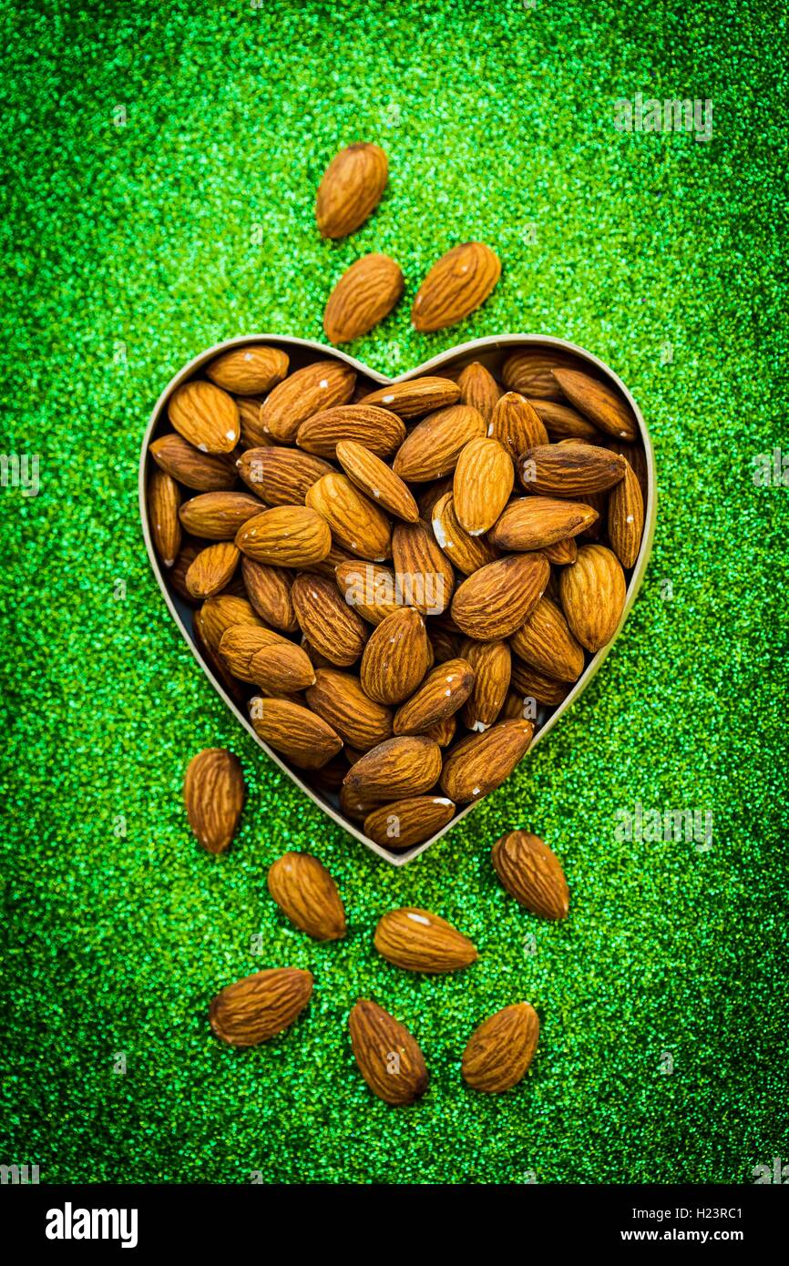 Almonds in heart shape. Stock Photo