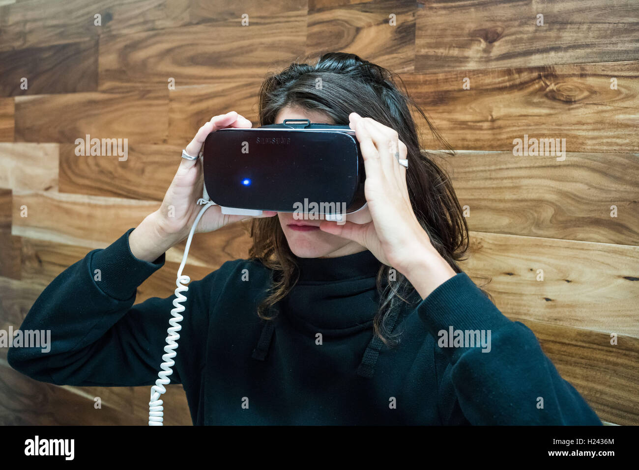 Woman wearing a virtual reality headset. Stock Photo