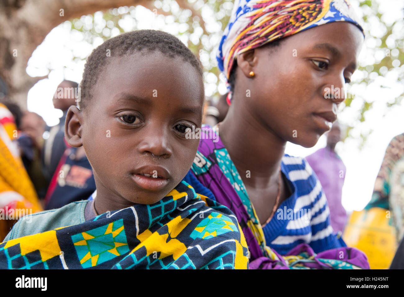 Chica district, Nampula Province, Mozambique, August 2015; Domingos Geraldo, Opthalmic Technician conducts a screening in Cavaia village.   This boy has trachoma. Photo by Mike Goldwater Stock Photo