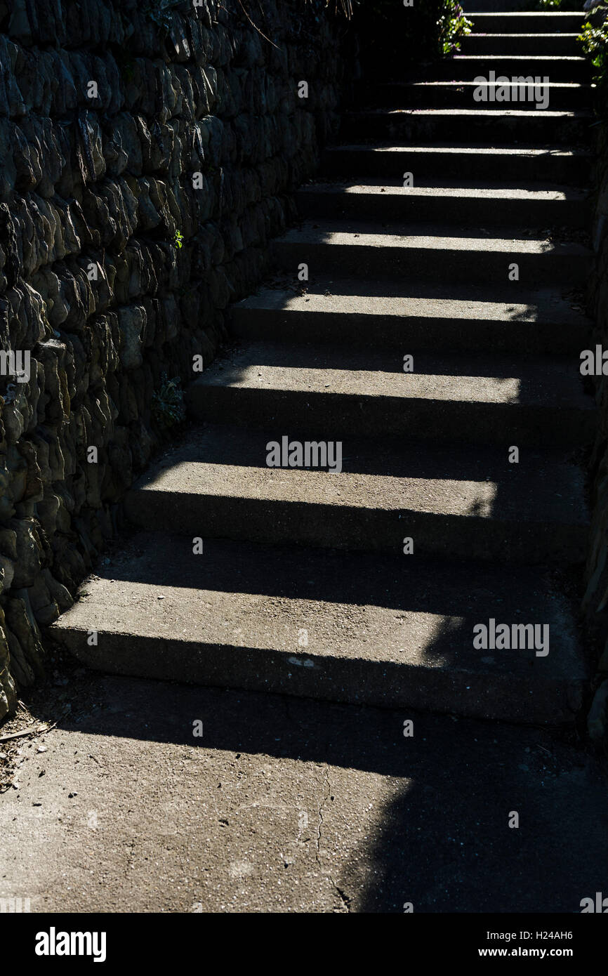 Stone Steps In Graphic Pattern In The Sunshine Adn Shadow Rising Up To stone-steps-in-graphic-pattern-in-the-sunshine-adn-shadow-rising-up-to