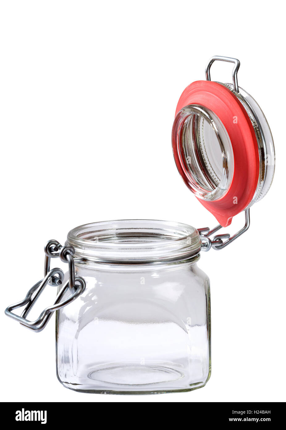 Empty glass jar with the open cap hold with metal wire isolated over the white background. Clipping path included Stock Photo
