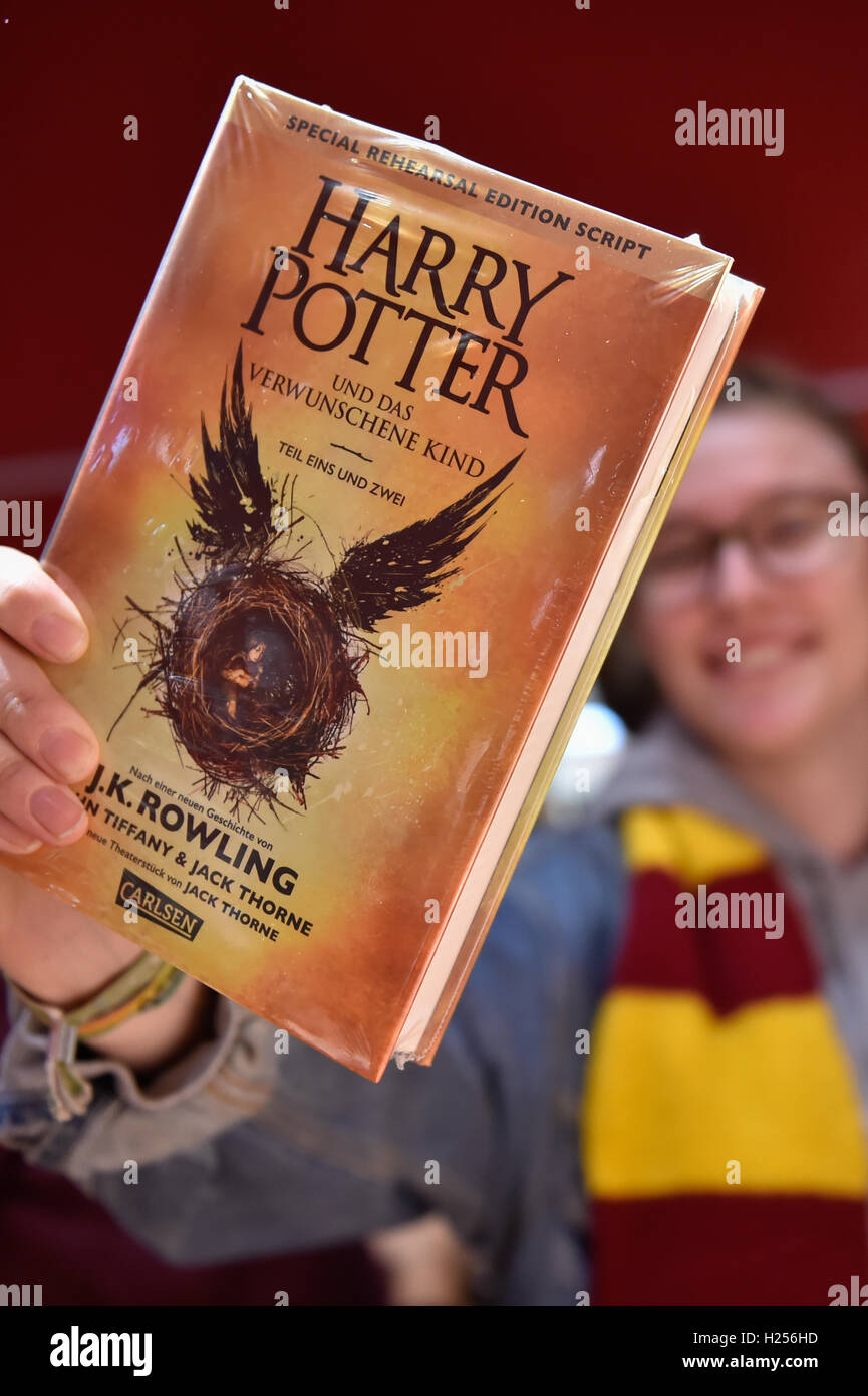 Berlin, Germany. 24th Sep, 2016. Julia from Berlin holds up her new Harry Potter book at the Kulturkaufhaus Dussmann in Berlin, Germany, 24 September 2016. The book entitled 'Harry Potter and the Cursed Child' has been available since midnight. Photo: KLAUS-DIETMAR GABBERT/dpa/Alamy Live News Stock Photo