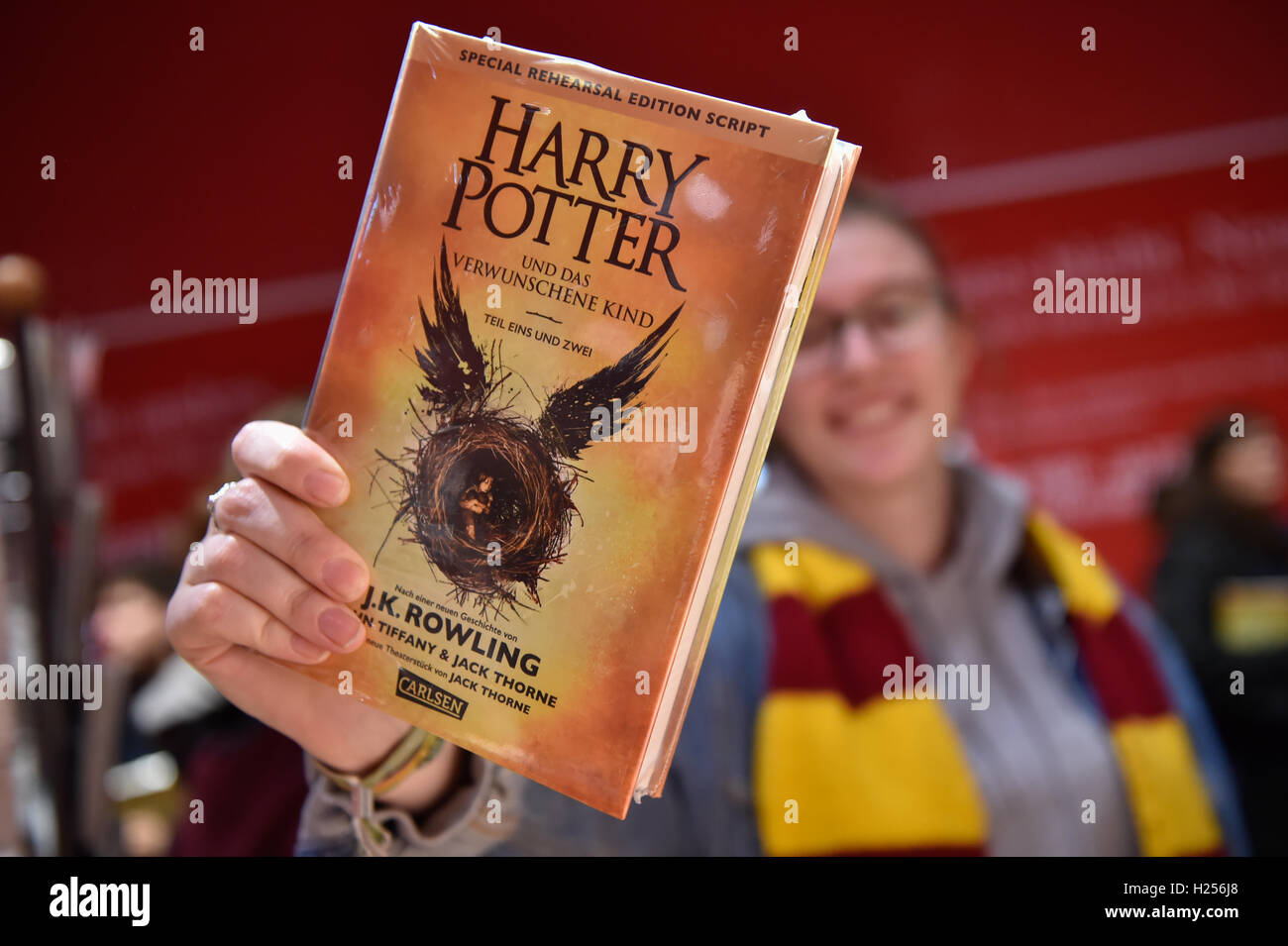 Berlin, Germany. 24th Sep, 2016. Julia from Berlin holds up her new Harry Potter book at the Kulturkaufhaus Dussmann in Berlin, Germany, 24 September 2016. The book entitled 'Harry Potter and the Cursed Child' has been available since midnight. Photo: KLAUS-DIETMAR GABBERT/dpa/Alamy Live News Stock Photo