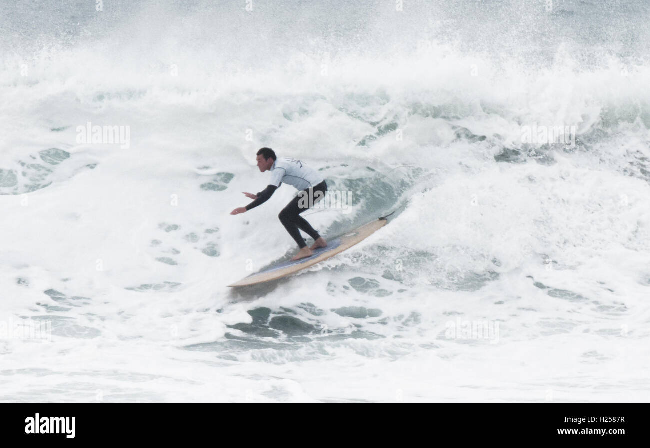 Epic white water huge wave being longboard surfed Fistral Bay UK Stock Photo