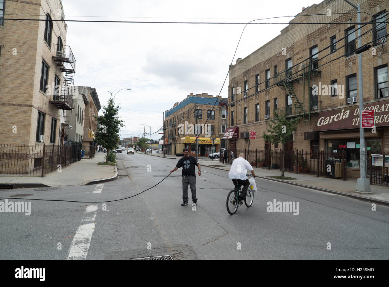 Ridgewood, USA, Sept. 24st, man dragging cable off the street