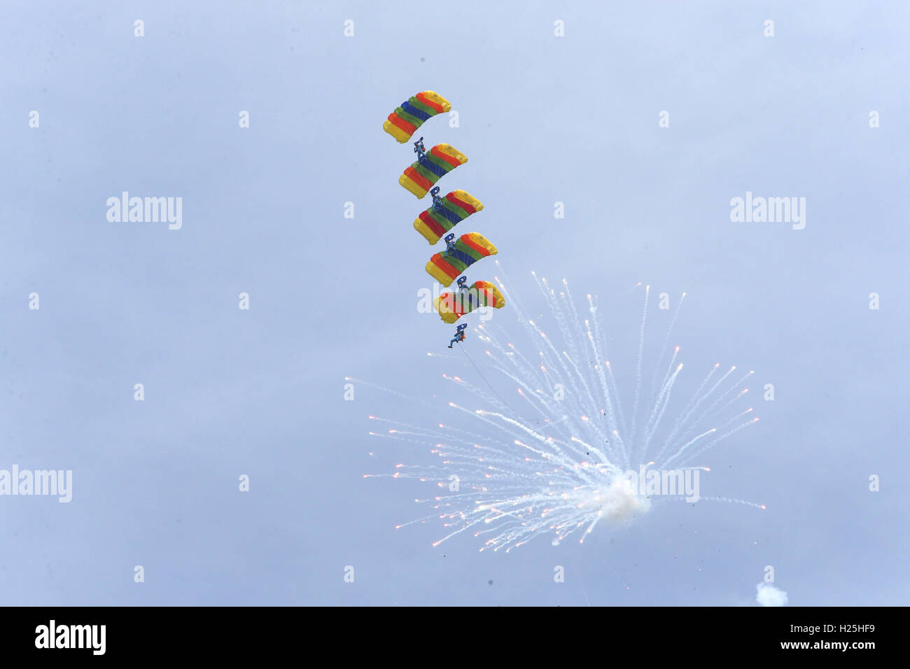 Pyongyang. 25th Sep, 2016. Parachutists perform during an international air show in Wonsan, the Democratic People's Republic of Korea (DPRK), on Sept. 25, 2016, the second day of the international air show. The Wonsan International Friendship Air Festival, the first of its kind in the DPRK, runs from Saturday through Sunday at Kalma International Airport, which was redesigned and reconstructed from a military airfield to promote tourism. Credit:  Guo Yina/Xinhua/Alamy Live News Stock Photo