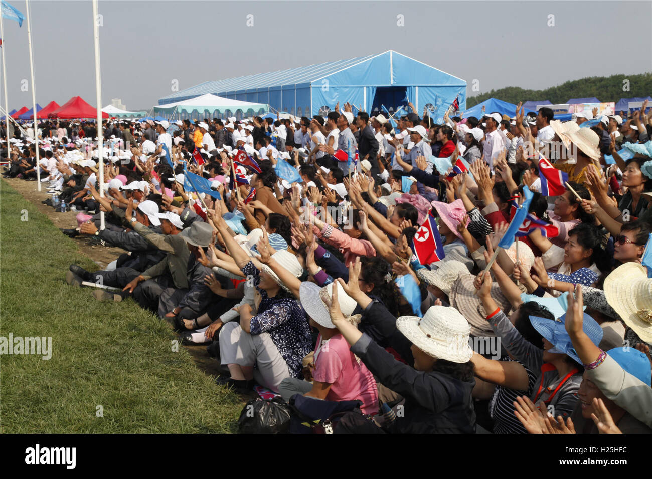 Pyongyang. 25th Sep, 2016. People wave to parachutists during an international air show in Wonsan, the Democratic People's Republic of Korea (DPRK), on Sept. 25, 2016, the second day of the international air show. The Wonsan International Friendship Air Festival, the first of its kind in the DPRK, runs from Saturday through Sunday at Kalma International Airport, which was redesigned and reconstructed from a military airfield to promote tourism. Credit:  Zhu Longchuan/Xinhua/Alamy Live News Stock Photo