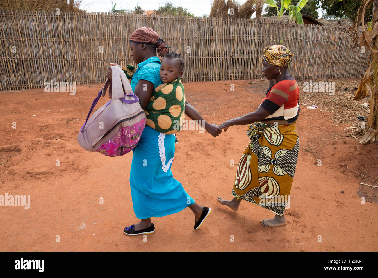 Namina village, Nampula Province, Mozambique, August 2015:  Maria Albino, 42, blind with bilateral cataracts is led by her daughter Elsa to the car that will take her to Ribaue Hospital for her first cataract operation to restore her sight.   Photo by Mike Goldwater Stock Photo