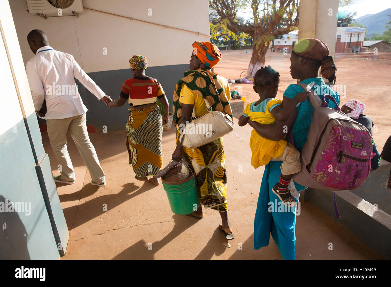 Ribaue Hospital, Ribaue,  Nampula Province, Mozambique, August 2015: Opthalmic Technician Domingos Geraldo, helps Maria Albino on arrival at Ribaue Hospital in preparation for  her first cataract operation to restore her sight.  Photo by Mike Goldwater Stock Photo
