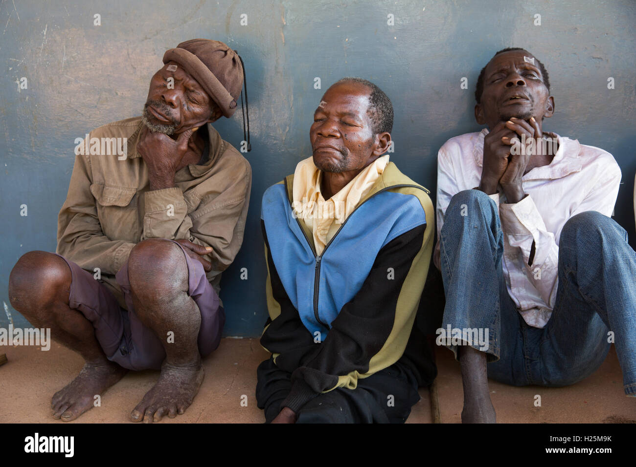 Ribue Hospital, Nampula Province, Mozambique, August 2015: Left to right, Pacuneta Peteia, a blacksmith from Mecuburi, Vasco Larawiaca and Apostino Almeita, 49, all from Mecuburi, awaiting their cataract operations. Photo by Mike Goldwater Stock Photo
