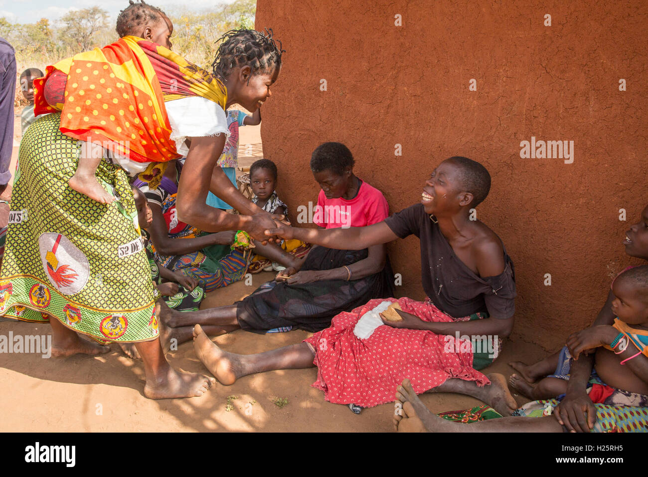 Lalaua district, Nampula Province, Mozambique, August 2015: Laurinda Diago greets with friends and family at home after cataract operations in both eyes have restored her sight.    Photo by Mike Goldwater Stock Photo