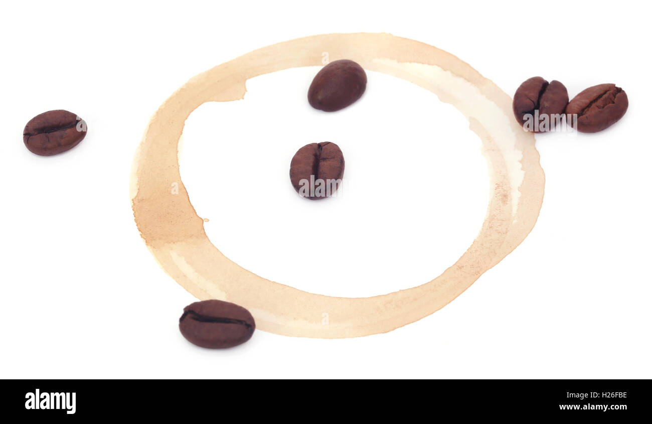 Roasted coffee with cup stain over white background Stock Photo