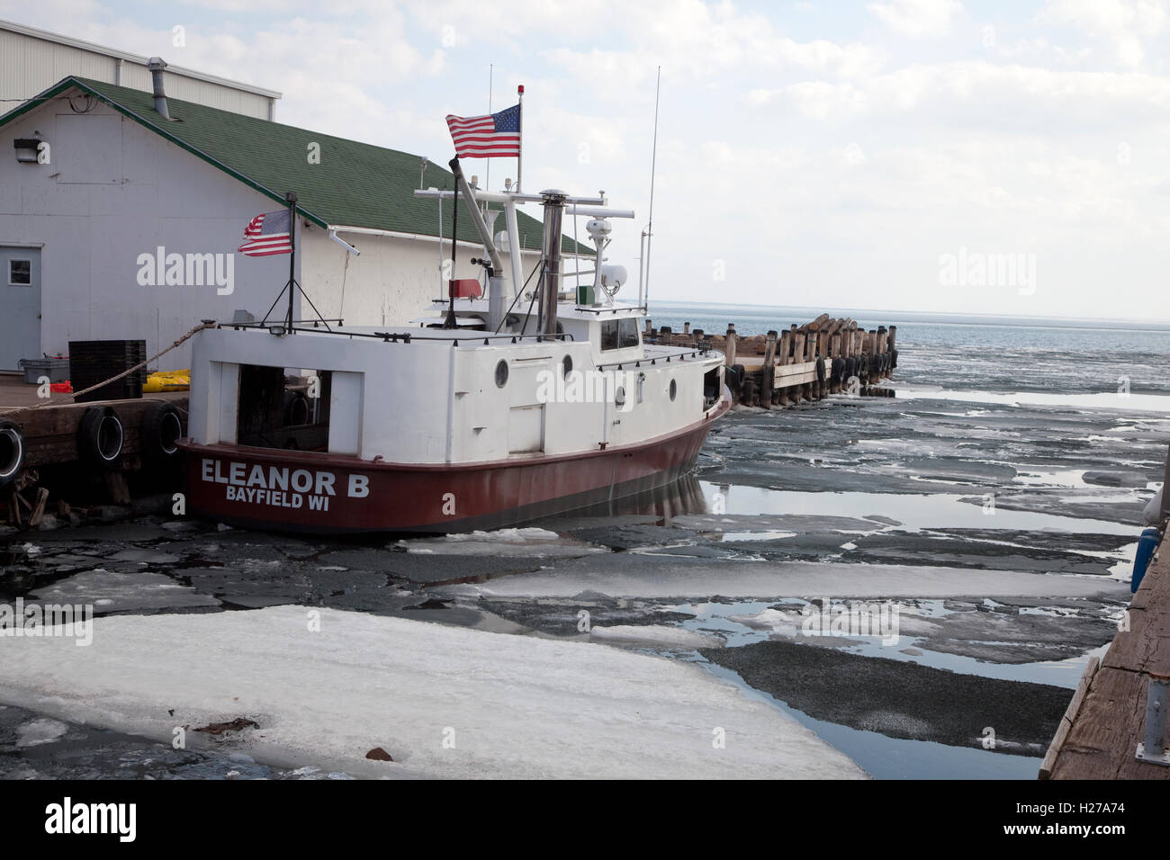 Fishing all-steel tug called the Eleanor B breaks ice on Lake Superior Bayfield Wisconsin WI USA Stock Photo