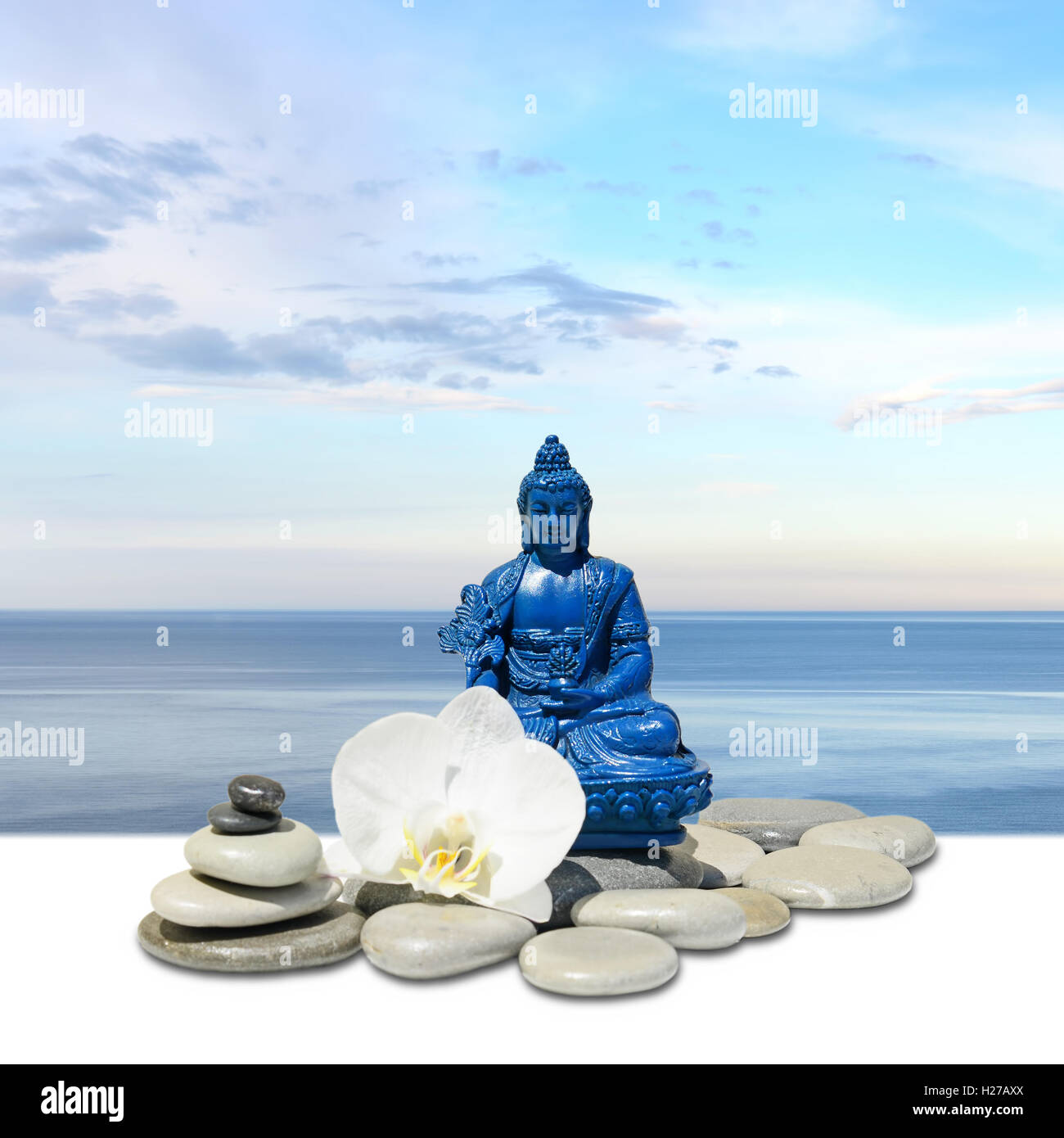 Blue Medicine Buddha Bhaisajyaguru,zen stone,white orchid flowers and sky Stock Photo