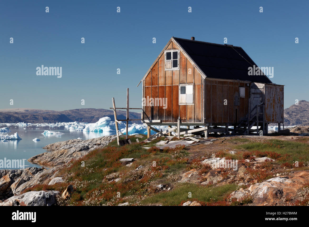 Red house in settlement of Tiniteqilaaq on Sermilik Fjord, East