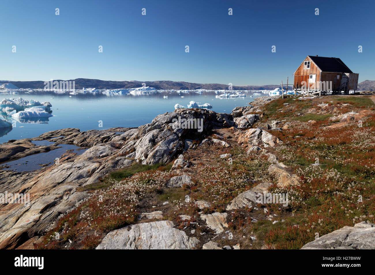 Red house in settlement of Tiniteqilaaq on Sermilik Fjord, East