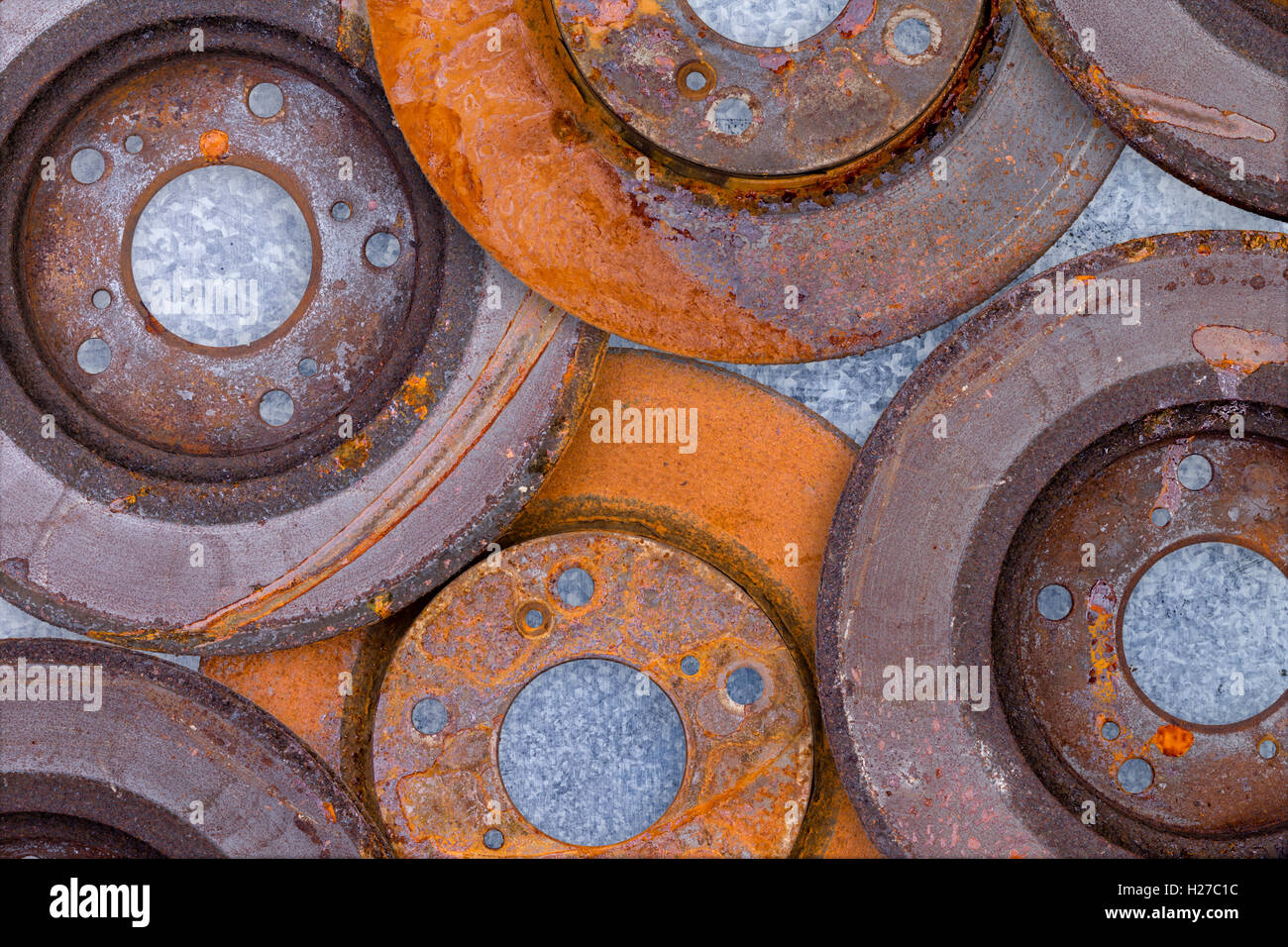 Layer of overlapping old rusty brake rotors with advanced corrosion and