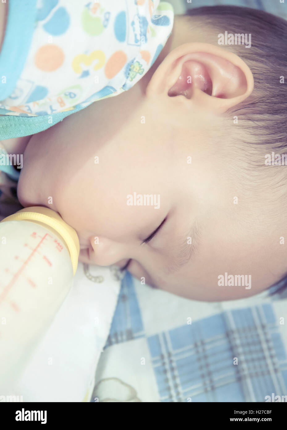 closeup baby drinking milk while sleeping Stock Photo