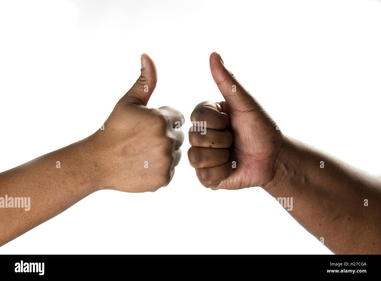 Male & female African hands giving each other the thumbs up sign Stock