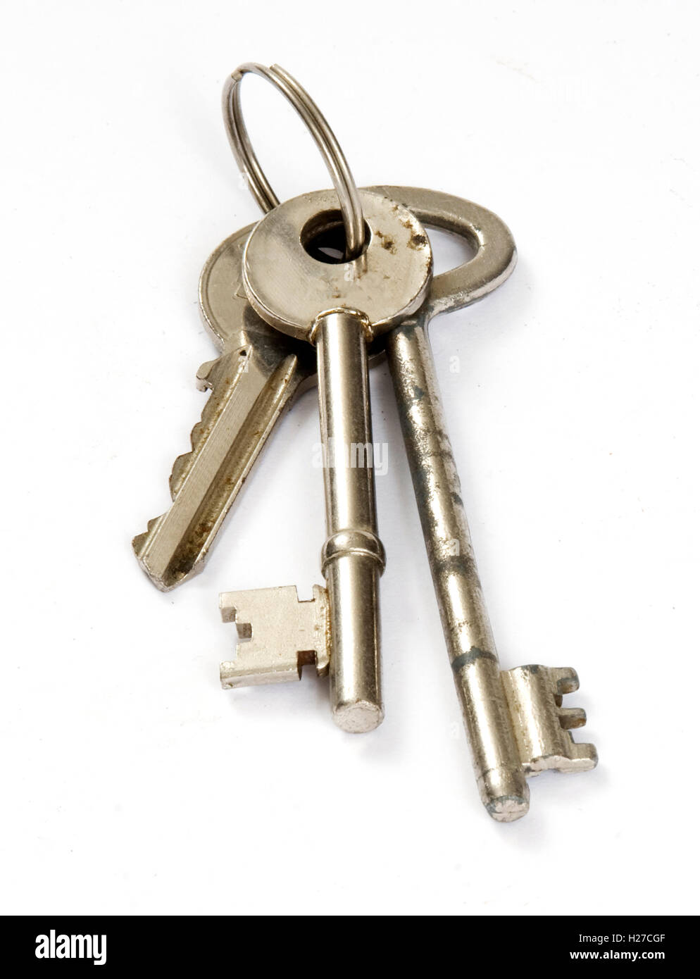 Three rusty old keys on a ring. studio shot on white background. Stock Photo