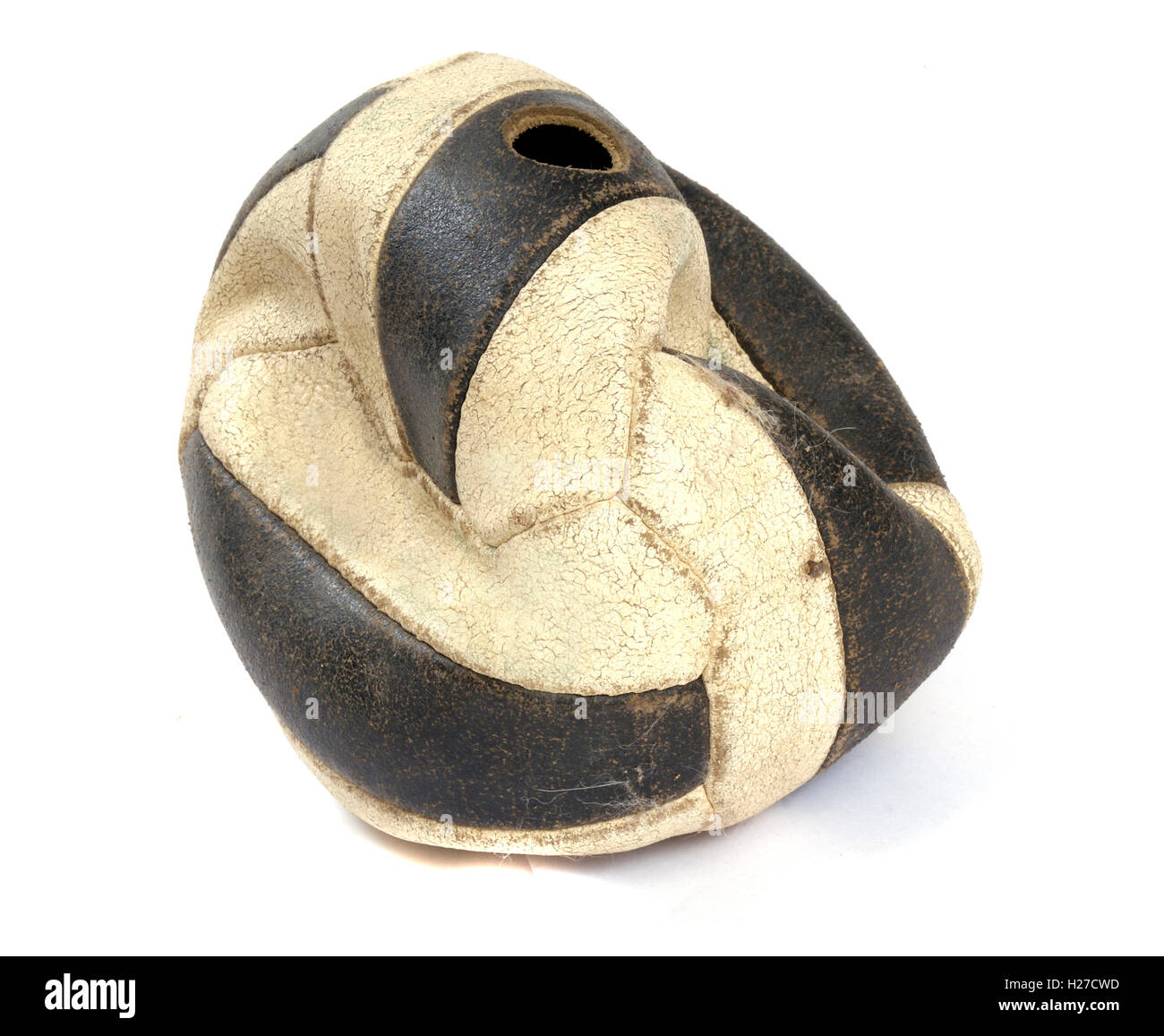 Old punctured leather black and white football. Stock Photo
