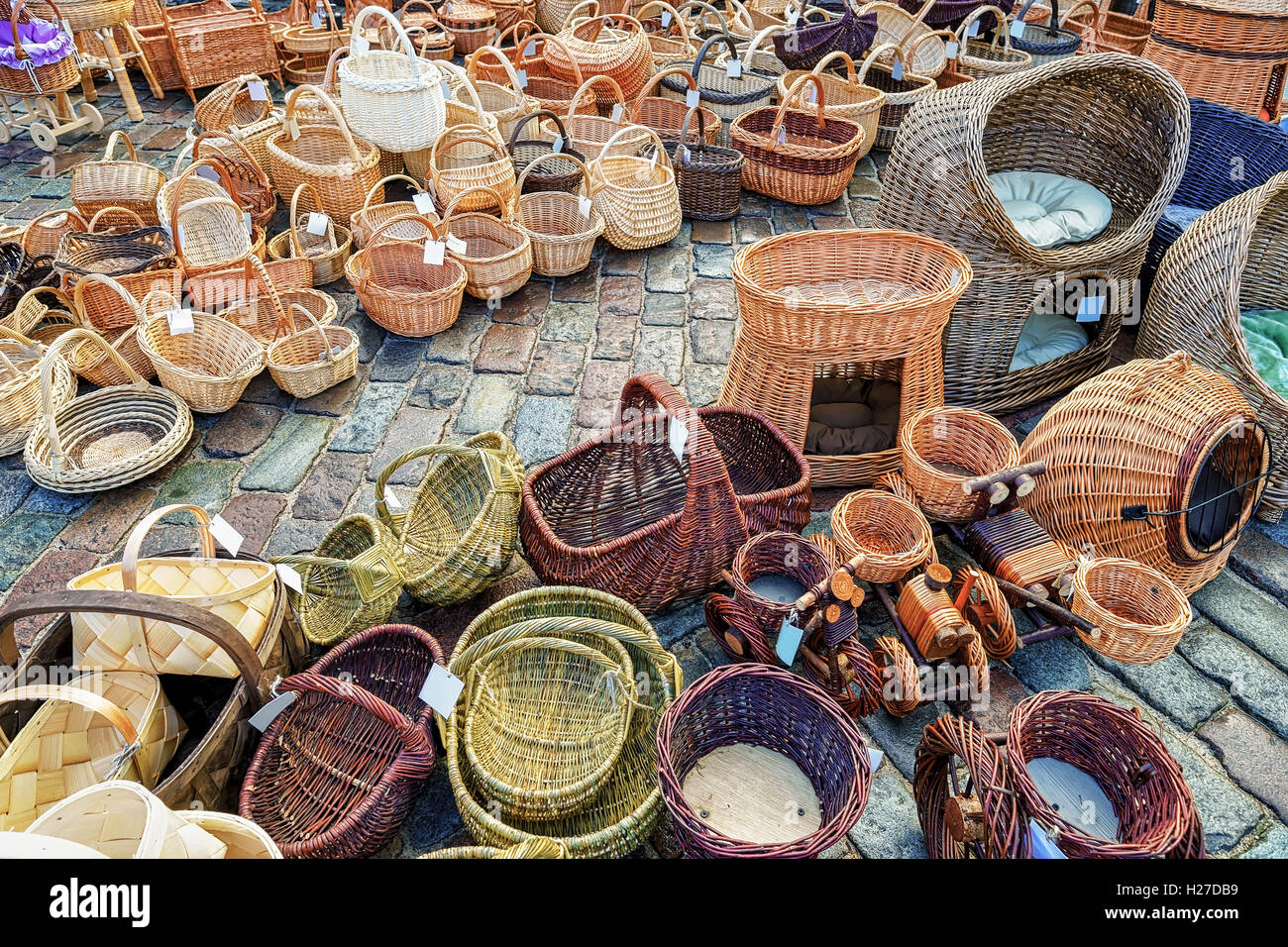 Straw baskets in different shapes and sizes on the display for sale at