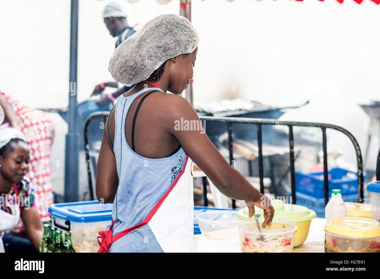 Abidjan, Ivory Coast, September 11, 2016: Young woman doing the cooking at the barbecue party in Abidjan. Stock Photo