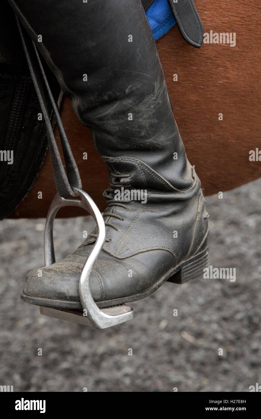Riders safety stirrup. A riding boot positioned into a bent leg safety ...