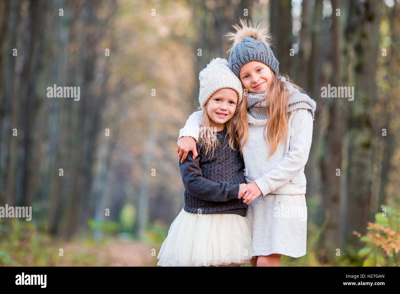 Little adorable girls outdoors at warm sunny autumn day Stock Photo - Alamy