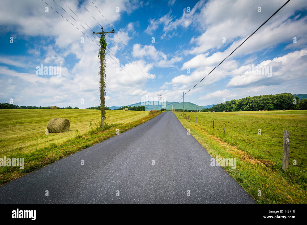 Country road with distant mountains and farm fields in the rural Shenandoah Valley, Virginia. Stock Photo