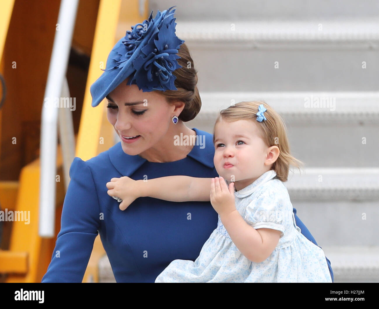 The Duchess of Cambridge carries Princess charlotte, as she and her husband the Duke of Cambridge and their son Prince George are greeted by the Prime Minister of Canada Justin Trudeau and his wife Sophie as the Royal party arrive at Victoria International Airport, in Victoria, Canada, on the first day of their official tour of Canada. Stock Photo