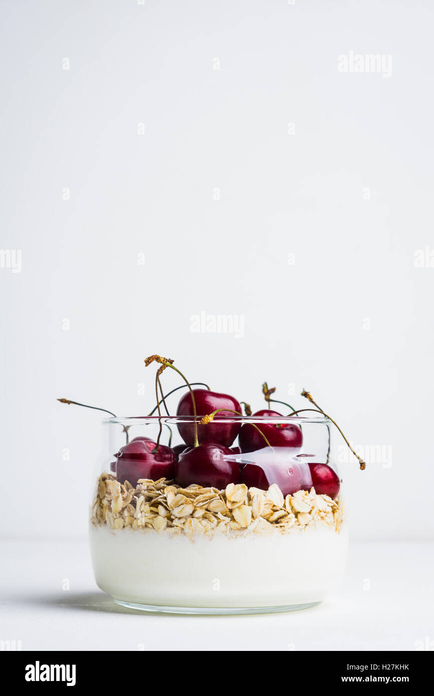 Homemade breakfast with white plain yogurt and cherries on the wooden