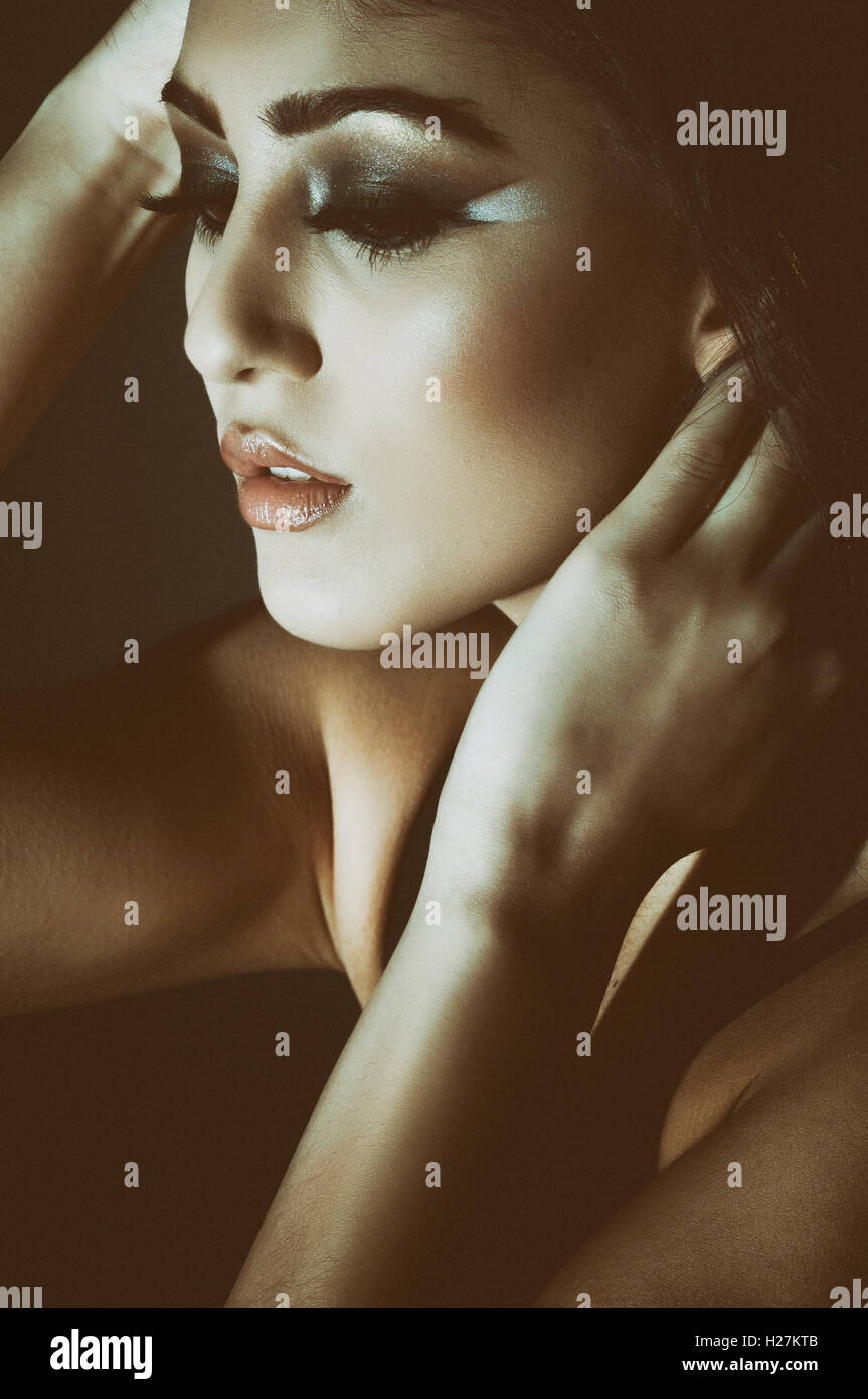 Beautiful young woman eyes closed hand touching face Stock Photo - Alamy