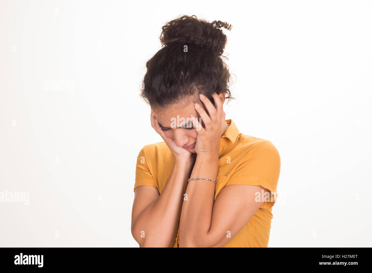 Upset young woman head in hands crying Stock Photo