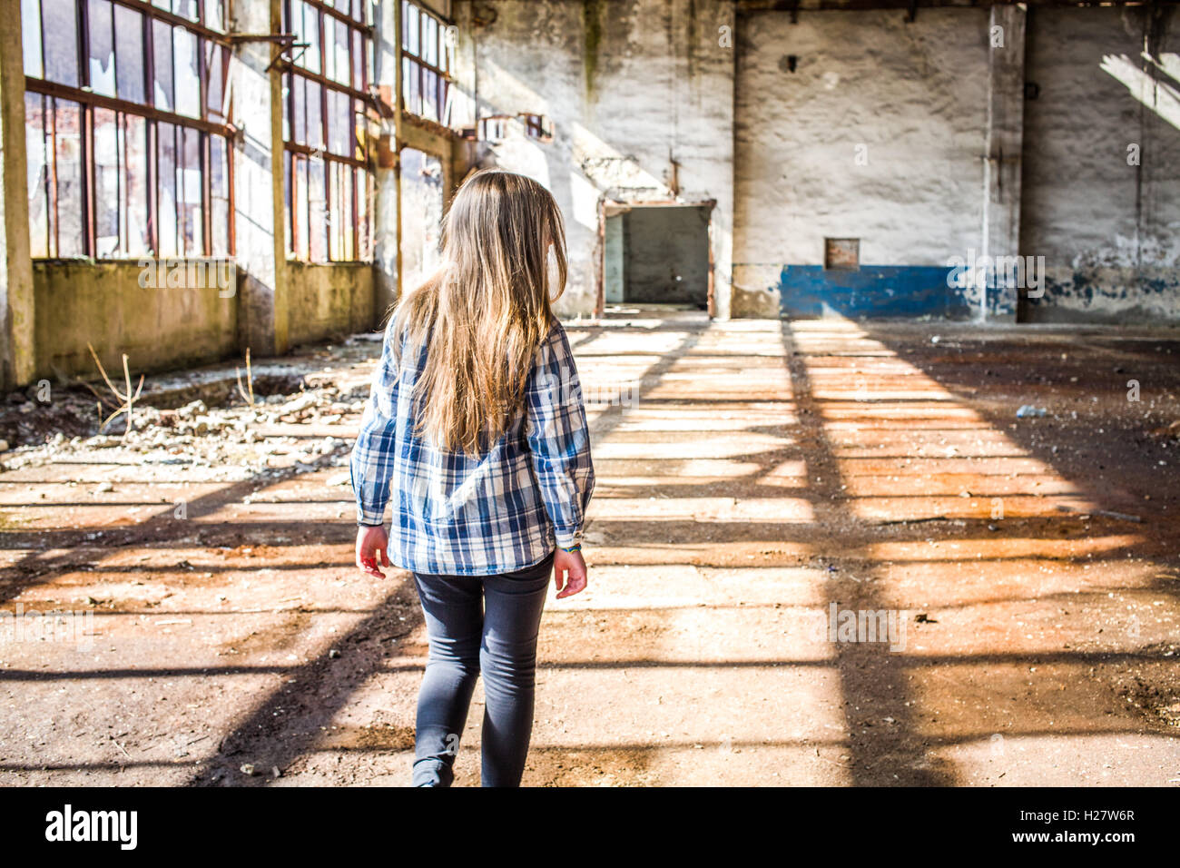 Little Girl in Empty Factory Stock Photo