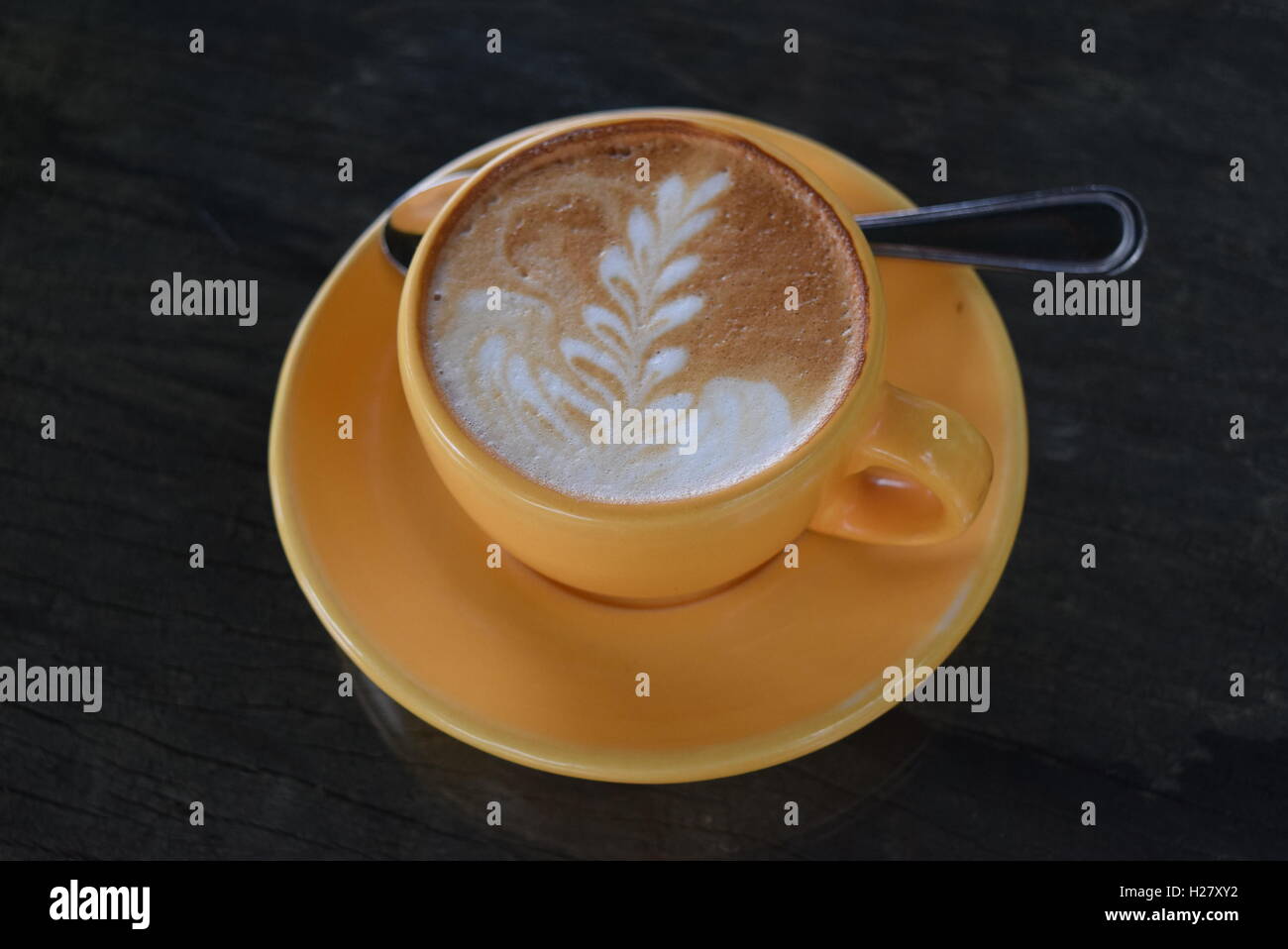 Cup of cappuccino or coffee latte with spoon and leaf decoration at Finca  Filadelfia, Antigua, Guatemala Stock Photo - Alamy