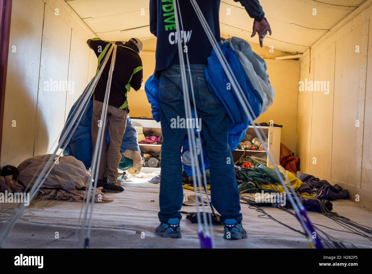 Parachute packers prepare skydiving equipment for new jumps at