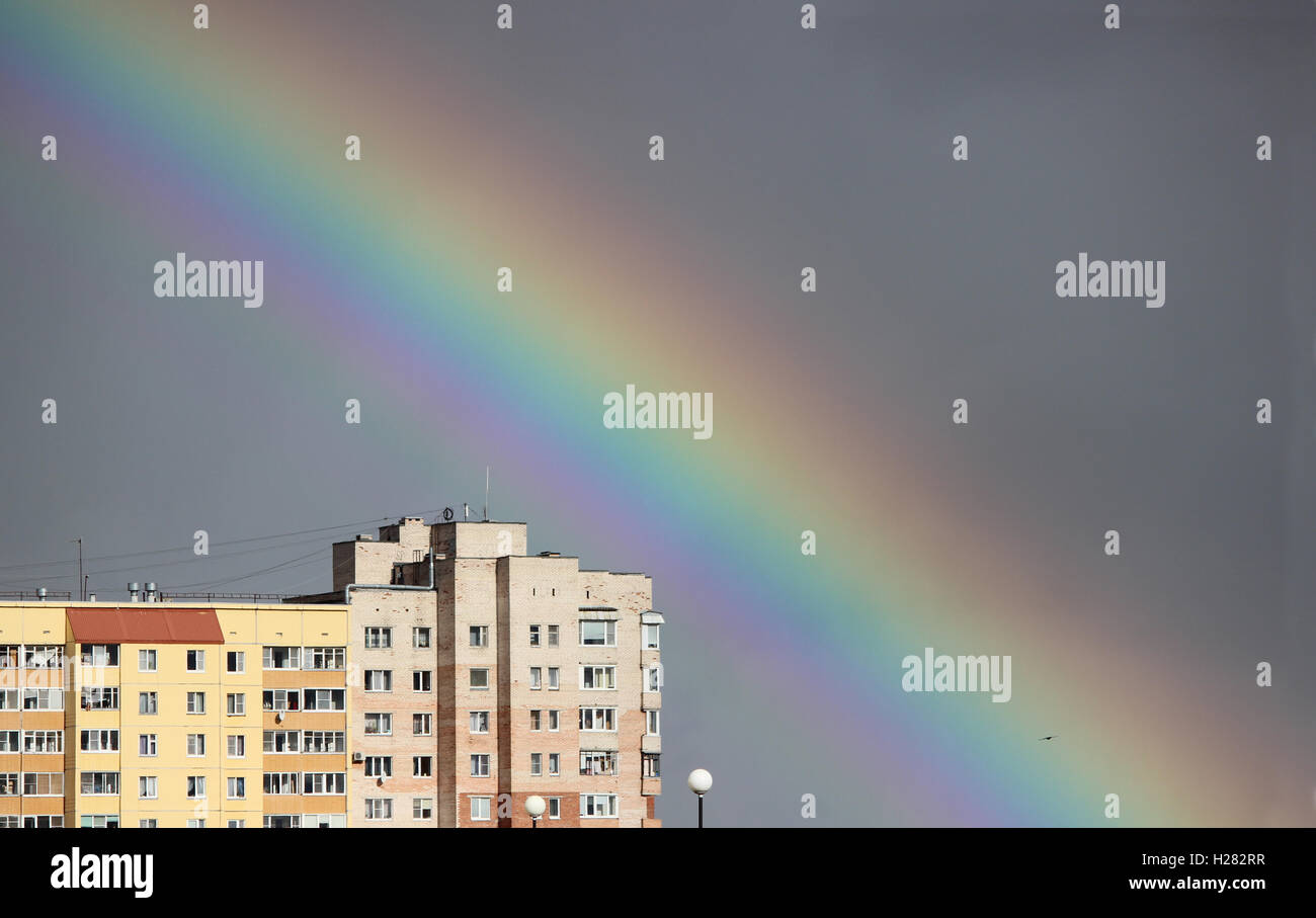 Bright multi-colored wide colorful rainbow after the storm in the gray ...