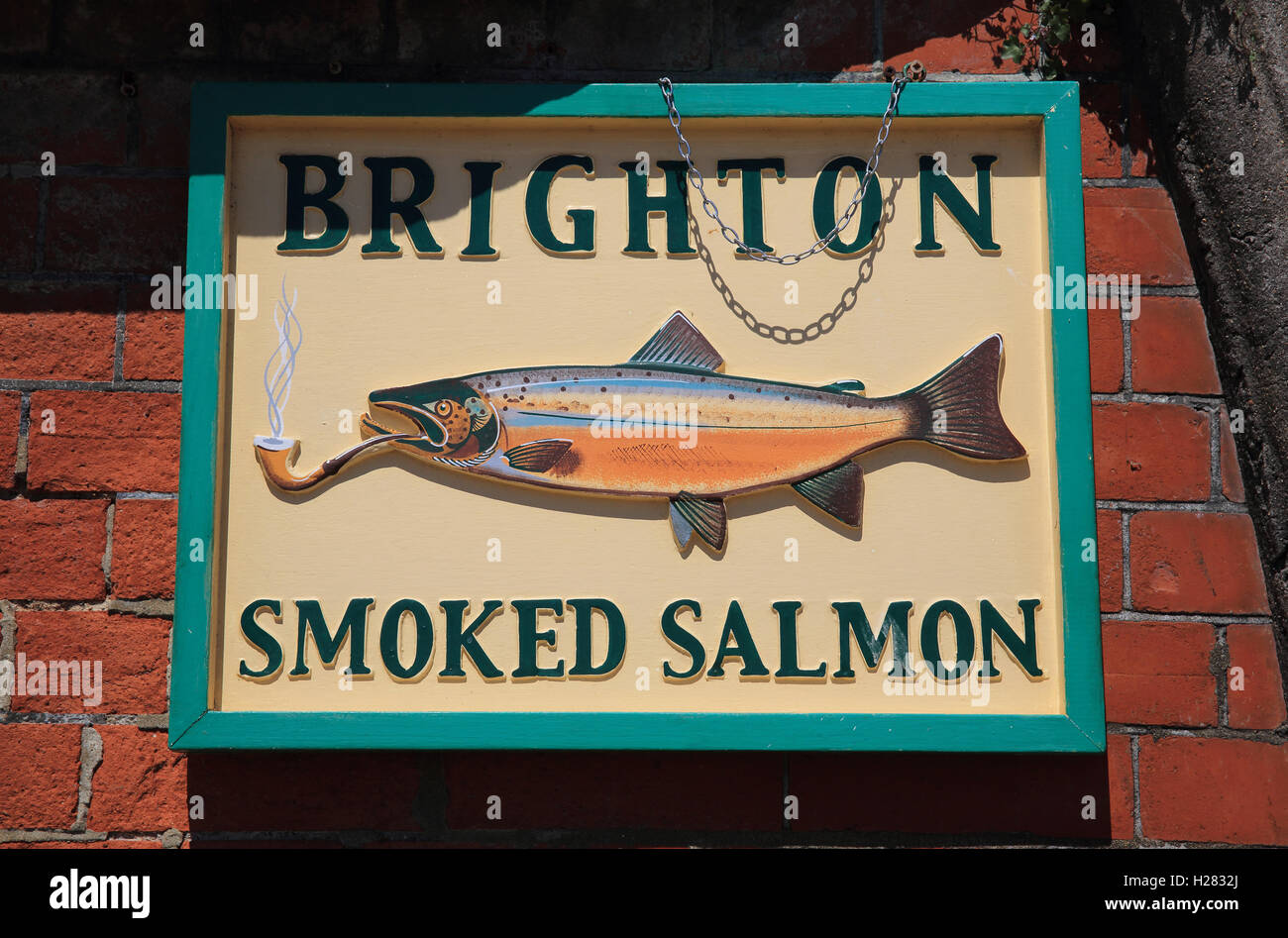 Retro smoked salmon sign on the wall of Kings Road Arches, in Brighton, East Sussex, SE England, UK Stock Photo