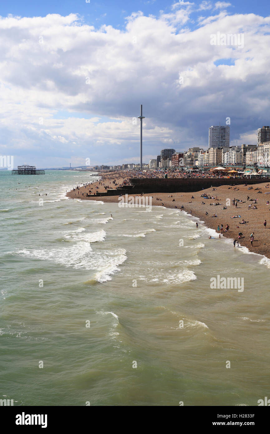 The view over Brighton beach from the Palace Pier, with the new i360 on the horizon, in East Sussex, England, UK Stock Photo