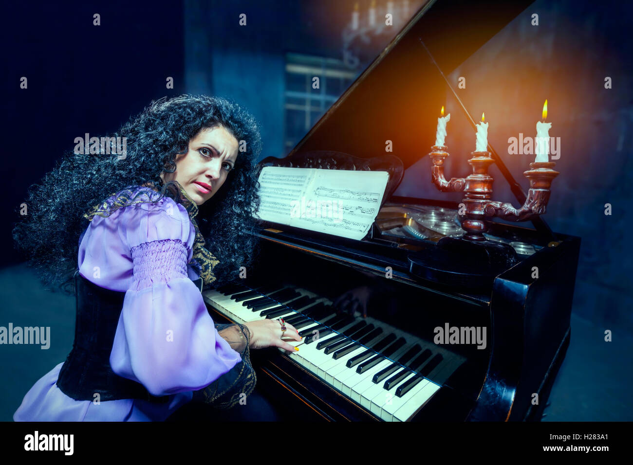 Woman playing the piano Stock Photo