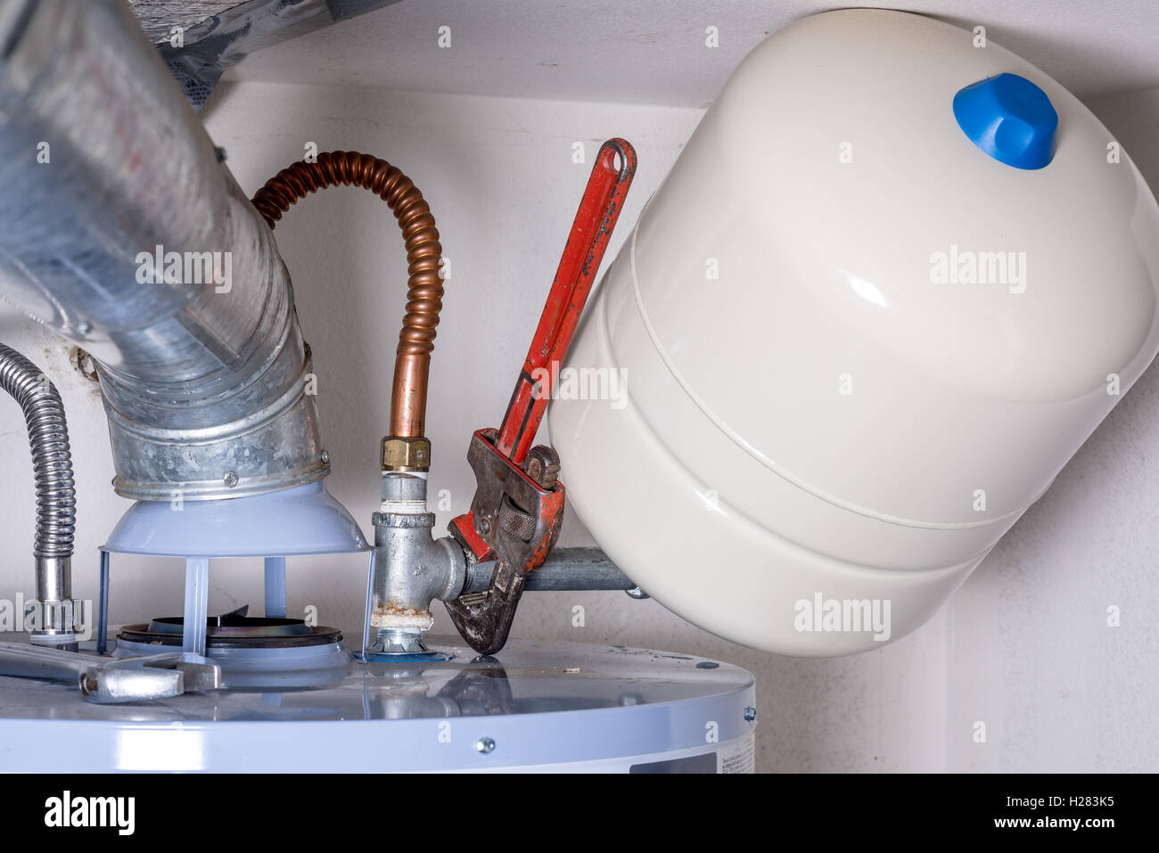 Maintenance on a hot water heater compression tank Stock Photo